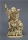 A Japanese Meiji period okimono carving of a figure with a staff, a youth by his side height 13cm                                      