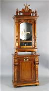 A late 19th century German walnut cased upright Symphonion, W.2ft 6in. D.1ft 4in. H.7ft 5in.                                           