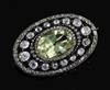 A Victorian gold and silver, pale green beryl and diamond set oval brooch, 36mm.                                                       