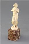 An Art Nouveau French ivory carved figure of a lady with a dove, height 6.5in.                                                         