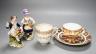 A Derby Imari saucer, a similar tea cup, a pair of Sampson Hancock, Derby figures, and a Derby cup, tallest figure 13 cms high.                                                                                             