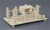 A 19th century Indian carved ivory group of a nobleman being carried in a sedan chair, attended by servants, 9in., height 3.75in.      