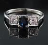 A 1930's platinum, sapphire and diamond three stone ring, size R.                                                                      