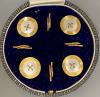 A cased set of four early 20th century 9ct and mother of pearl set buttons                                                                                                                                                  