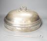 A silver plated cloche / meat cover and a plated meat skewer                                                                                                                                                                