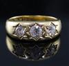 A late Victorian 18ct gold and gypsy set three stone diamond ring, size N/O.                                                           