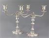 A pair of late 1960's silver two branch, two light candelabra by James Dixon & Sons, weighted.                                         
