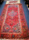 A Caucasian design red ground rug and a mat 186 x 100cm and 90 x 49cm                                                                  