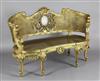 An early 20th century carved giltwood canapé, W.4ft 7in. H.3ft 1in.                                                                    