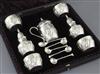 A cased Victorian repousse silver seven piece condiment set by James Deakin & Sons Ltd,                                                