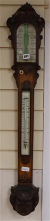 A Victorian carved oak stick barometer by G. I. Lowther, Newcastle on Tyne, in carved oak case with ivory scales and lion's head reserv