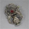 An Art and Crafts white metal and cabochon ruby brooch, modelled as two birds with a vase, 40mm.                                       