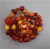 A graduated amber bead necklace, some beads carved with insects or animal heads, gross weight 119 grams, 88cm.                         