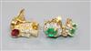 A pair of 14ct gold, emerald and diamond earrings and a pair of 18ct gold, ruby and diamond earrings                                   