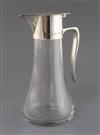 A silver-mounted glass claret jug of tapered form, Birmingham 1972, maker Robert Welch, 25cm.                                          