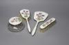 A four-piece silver plated and enamel dressing table set                                                                                                                                                                    