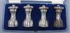 A cased set of four George V silver capstan shaped pepper mills, Hukin & Heath Ltd, Birmingham 1913, 91mm.                             