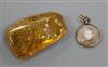 A circular yellow metal locket with photographic portrait and lock of hair verso and a piece of amber, approx 6 x 4cm                  