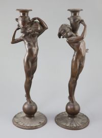 After Edward Francis McCartan (1879-1947). A pair of Art Nouveau bronze candlesticks, height 16.75in.                                  