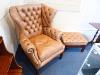 A pair of George III style buttoned tan leather wingback armchairs and two matching footstools                                                                                                                              