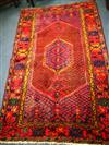 An Eastern red ground rug, woven with a central elongated hexagon 215cm x 135cm                                                        