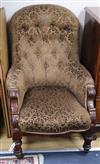 A Victorian mahogany spoonback armchair                                                                                                