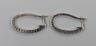 A pair of modern white metal and diamond chip set half hoop earrings, 27mm,gross weight 5.9 grams.                                                                                                                          
