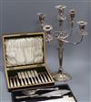 A cased plated dessert eaters, A cased pair of fish servers and plated candlesticks                                                    