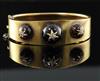 A Victorian gold, three graduated cabochon garnet and diamond set hinged bracelet, gross 29 grams.                                     