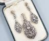 A 19th century pierced white and yellow metal and rose cut diamond set suite of jewellery, comprising a pendant 48mm and a pair of matching drop earrings, gross weight 11.2 grams.                                         
