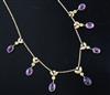 An Edwardian 15ct gold, amethyst, peridot and seed pearl set drop necklace, 40cm.                                                      