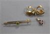 A 9ct gold ribbon bow brooch, a 9ct and gem set bar brooch and a 9ct gold gem set pendant.                                             