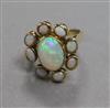 A 9ct gold and nine stone white opal cluster ring, size N.                                                                             