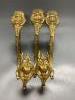 A pair of French ornate gilt curtain tiebacks and a set of three similar curtain brackets                                                                                                                                   