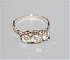 An 18kt white metal and three stone diamond ring, total diamond weight approximately 1.00ct, size O.                                   