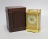 A cased French gilt brass carriage timepiece with relief cast dial and engraved presentation inscription - 14cm tall                                                                                                        