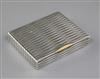 A 1940's Cartier silver cigarette case with 18ct gold thumbpiece, 9.5cm.                                                               