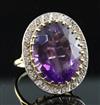 A large gold, amethyst and diamond set oval dress ring, size S.                                                                        