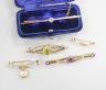 Five assorted early 20th century yellow metal and gem set brooches, including one 9ct and one with turquoise set heart drop and one with peridot, largest 62mm, gross 11.7 grams.                                           