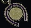 A gold and synthetic ruby? set horseshoe pendant with inset with 1899 United States of America Liberty coin, on a 9ct gold chain,      