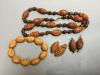 A Chinese peach stone or nut bead necklace, bracelet, a pair of earrings and two carved beads                                                                                                                               