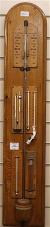 An oak barometer by S & B Solomon, 39 Albemarle Street, London, fitted four thermometers and storm glass (empty) H.100cm               