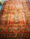 A red ground rug 350 x 248cm                                                                                                           