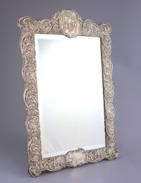 An Edwardian repousse silver mounted toilet mirror, Henry Matthews, Birmingham, circa, 1905,                                           