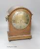 An Edwardian inlaid mahogany mantel clock, with lion mask ring handles, with key and pendulum, height 38cm                                                                                                                  