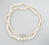An early 20th century single strand graduated pearl necklace(not tested for natural or cultured), with diamond set white metal clasp, 49cm, largest pearl diameter 7.1mm, smallest 2.1mm, gross weight 10 grams.            