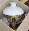 A brass hanging oil lamp with white glass shade                                                                                        