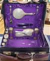 A George V travelling toilet case containing twelve matches silver mounted toilet jars etc.                                            