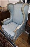 A pair of Louis XVI design grey painted armchairs, upholstered in a patterned blue fabric                                              