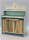 A collection of Beatrix Potter books in cabinet                                                                                        
